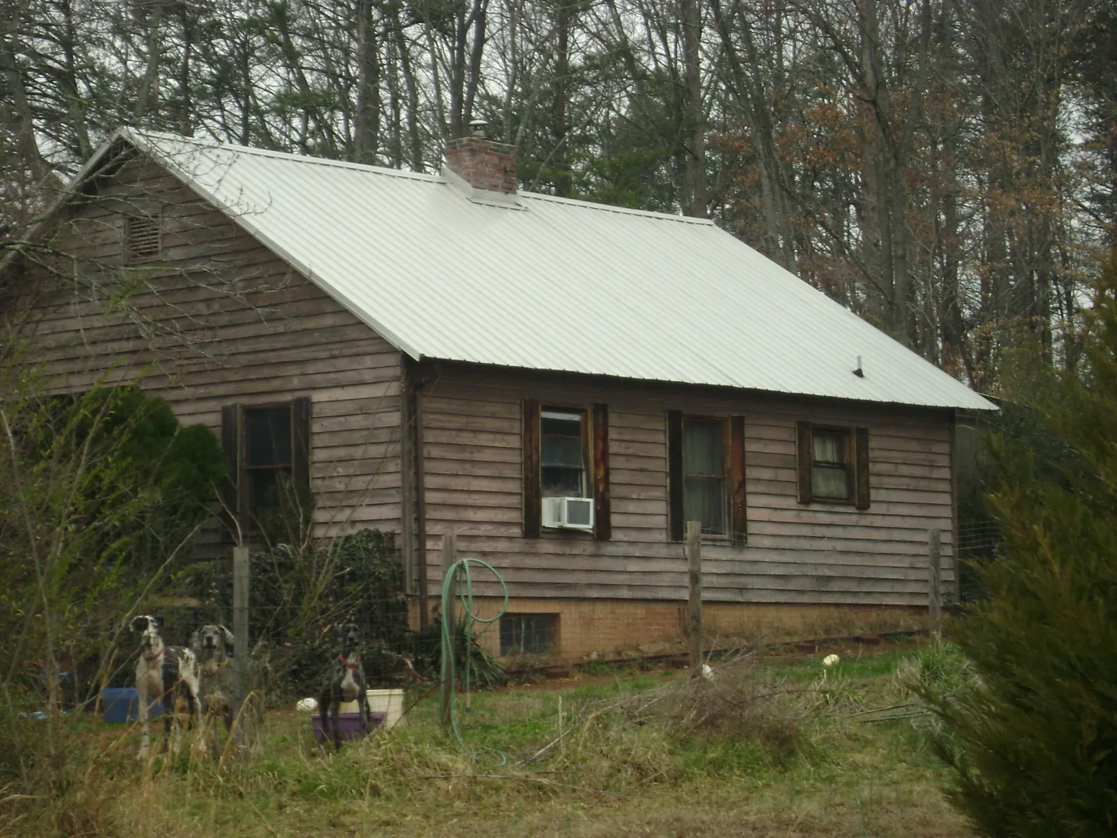 White metal roof on an old wood sided farmhouse, from a Metal Roof Installation job in Willow Springs